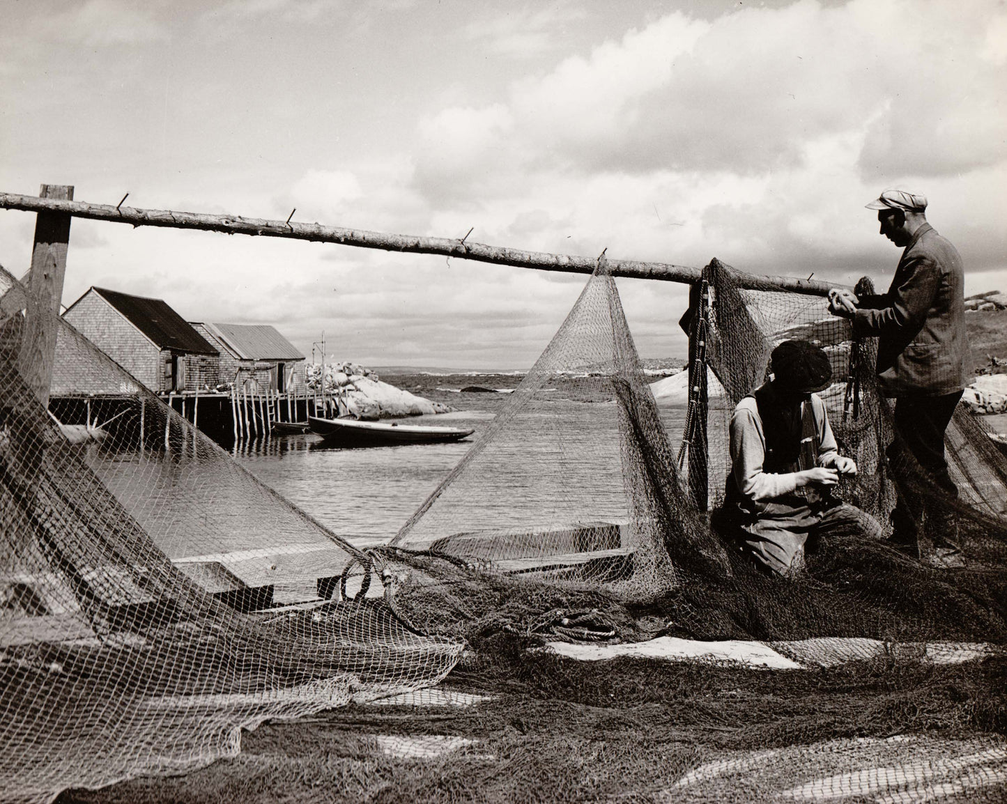 Fishermen mending nets at Peggy's Cove