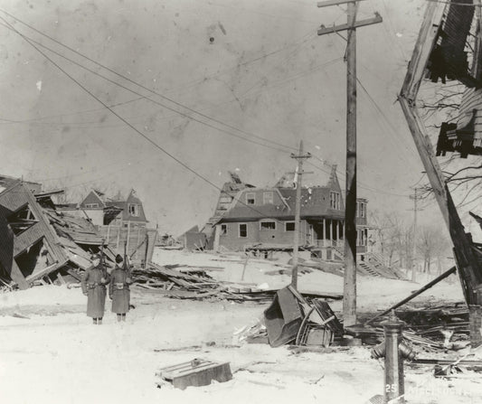 Soldiers standing guard in the midst of the devastation on Kaye Street east of Gottingen Street, Halifax