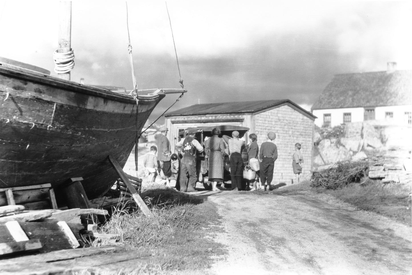 "Group gathered around early model van, Peggy's Cove, NS"