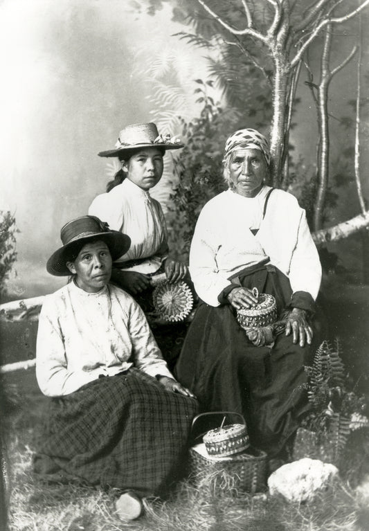 Three Mi'kmaq women holding woodsplint baskets