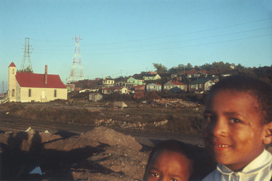 Two Africville children, with Seaview African United Baptist Church and houses behind it in the distance