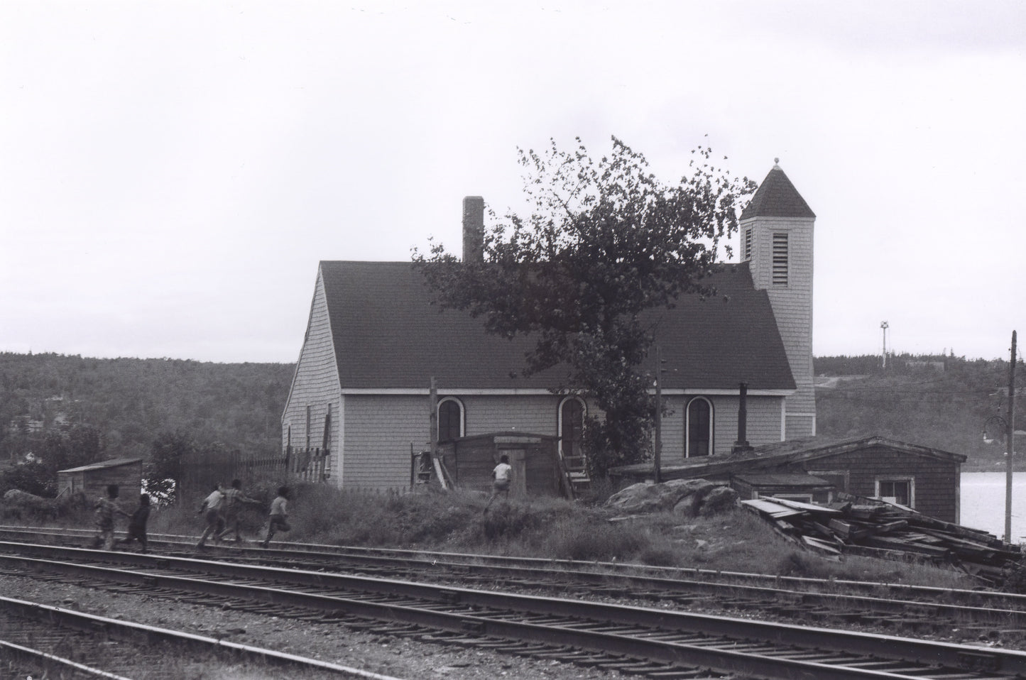 Boys crossing railroad tracks towards Seaview African United Baptist Church, Africville