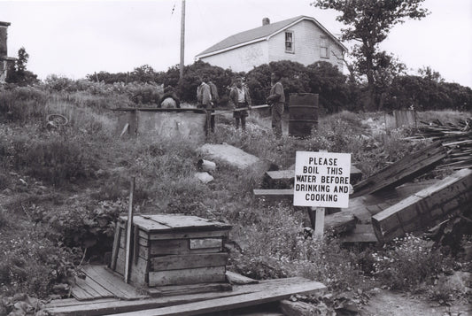 Another of Africville's wells with a sign reading, "Please boil this water before drinking and cooking"