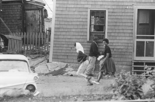 Two young women walking by a house, Africville