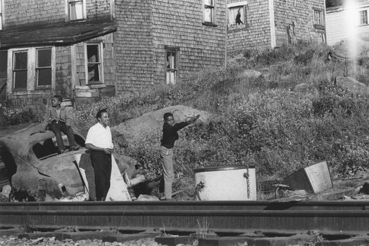 Young men playing horseshoes, seen from the opposite side of the railway tracks, Africville.