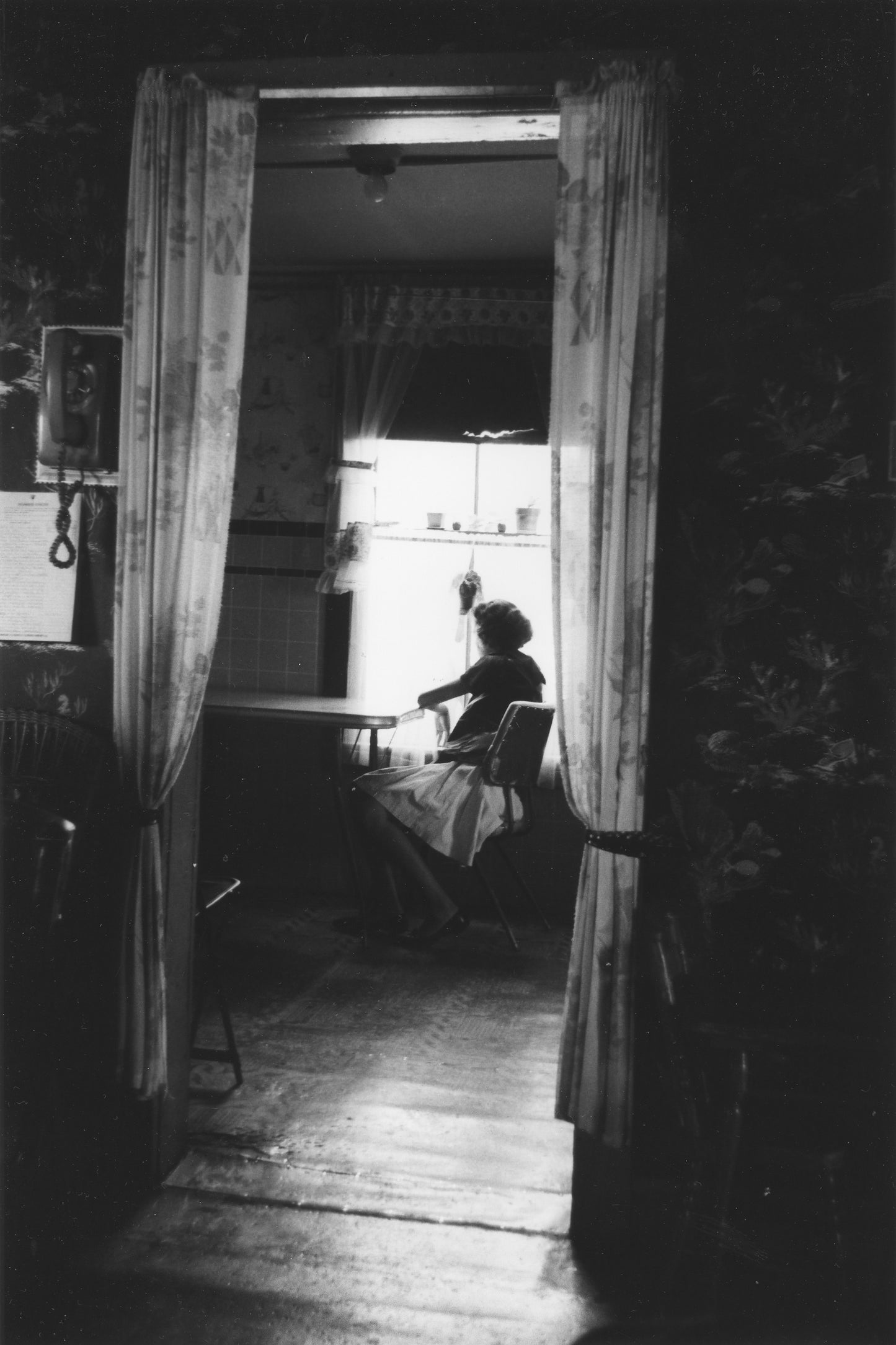 Woman sitting at kitchen table, Africville