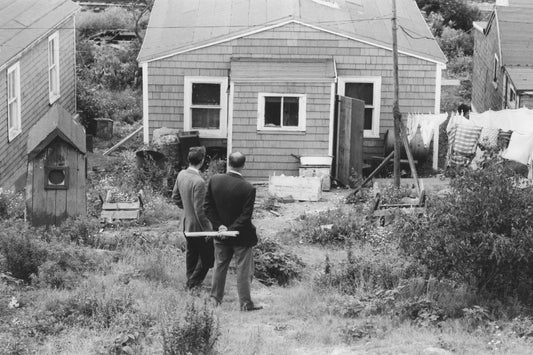 Two Halifax city officials outside an Africville house, prior to demolition of the community