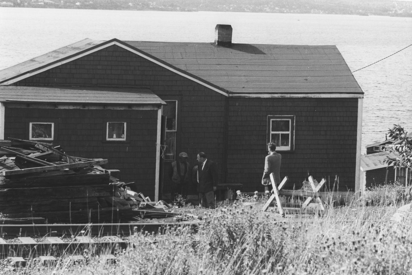 Halifax City official talking to an Africville resident by his back door, prior to demolition of the community