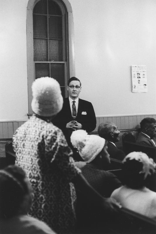 Woman directing a question to a Halifax city official during a public meeting at Seaview African United Baptist Church, Africville