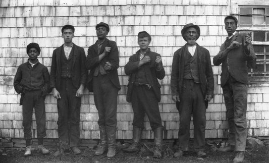 Six black men posing against the side of a building, Guysborough, N.S.