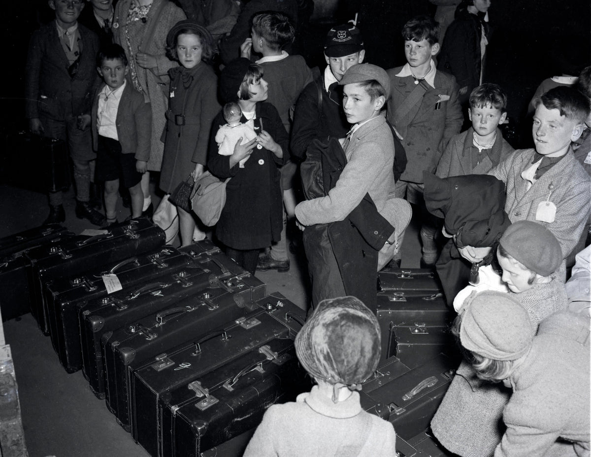 Several shots of a large group of people, including British evacuee children, collecting luggage on arrival in Halifax