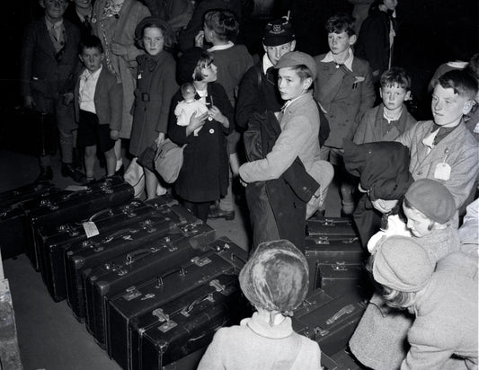 Several shots of a large group of people, including British evacuee children, collecting luggage on arrival in Halifax