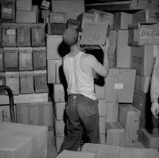 Loading a box car of the Canadian Pacific Railway