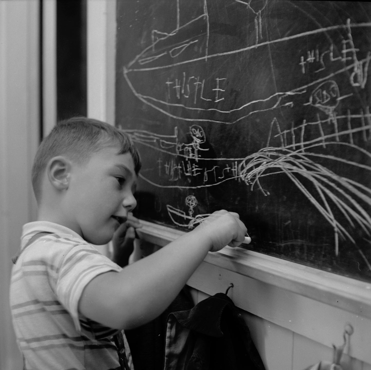 Ralph Clements, son of fisherman George Clements, draws boats.